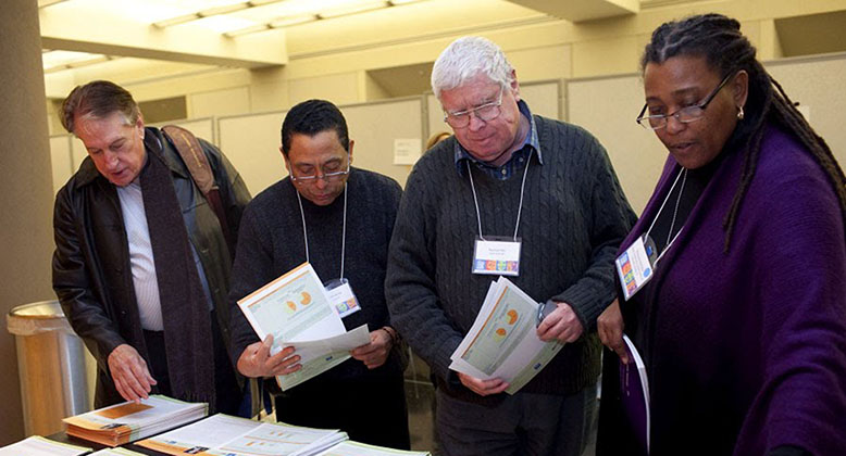 Group of people with NRC LGBT informational materials