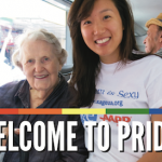 An older white woman and younger Asian woman on a SAGE Pride bus.