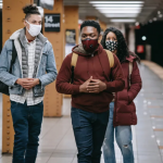 three-young-black-people-stand-in-subway