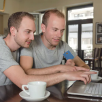 two-young-white-men-sit-at-computer