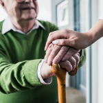 older-man-with-hands-on-a-cane