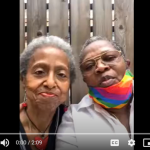 two-older-lesbian-women-with-rainbow-masks